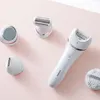A collection of Philips epilator attachments and a main epilator unit are arranged on a light pink surface. Podgląd zdjęcia produktu