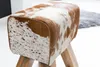 A close-up shot of a turnbock seat stool with a cowhide pattern. Produktbild-Vorschau