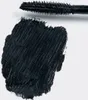 A swatch of black mascara is shown on a white background, with the mascara wand positioned above it. Náhled obrázku produktu