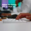 A person's hands are typing on a white keyboard in a close-up shot. The background is blurred and shows office-like environment with colorful lights. Náhled obrázku produktu