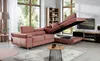 A modern living room with a pink sectional sofa that has been converted into a bed, revealing its storage space. A coffee table and TV stand are also visible. Produktbild-Vorschau