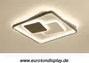 A modern square ceiling light with a dark frame and illuminated white squares inside, mounted on a light gray ceiling. Produktbild-Vorschau