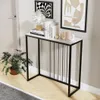 A console table with decorative items and a plant in a hallway. Produktbild-Vorschau