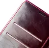 A close-up view of a burgundy leather flip phone case, showing stitching and card slots. Produktbild-Vorschau