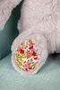 A close-up of a plush toy's foot with a floral pattern. Náhľad obrázku produktu