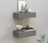 Two gray wall shelves mounted on a textured gray wall. Produktbild-Vorschau