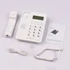 A white corded telephone and its accessories are laid out on a light gray surface. Náhľad obrázku produktu