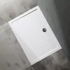 A white rectangular shower tray with a silver drain is shown on a gray tiled floor. Produktbild-Vorschau