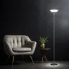 A modern living room scene with a tufted armchair, a small side table with a plant, and a floor lamp. Produktbild-Vorschau