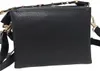 A black handbag with gold chain detail is shown from the back against a white background. Náhled obrázku produktu