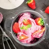 A close-up view of strawberry ice cream in a metal bowl, with fresh strawberries and mint leaves as garnish. Náhľad obrázku produktu