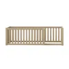 A wooden crib or bed frame with vertical slats and a gate. Produktbild-Vorschau