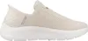 A side view of a beige Skechers slip-on sneaker. Náhľad obrázku produktu
