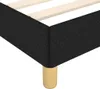 A close-up view of the corner of a black fabric bed frame with wooden slats and a single wooden leg. Náhled obrázku produktu