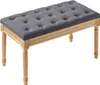 A gray upholstered bench with wooden legs against a white background. Podgląd zdjęcia produktu