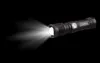 A black National Geographic flashlight emitting a bright beam of light against a black background. Produktbild-Vorschau