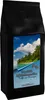 A black coffee bag with a tropical island scene and text on the front. Produktbild-Vorschau