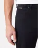 Close-up of a person's arm and the pocket area of black jeans. Produktbild-Vorschau