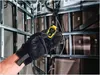 A gloved hand holds a yellow and black DeWALT distance measuring device in front of a metal frame wall with insulation and wiring. Anteprima dell’immagine prodotto