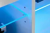 Close-up view of a shelf with blue LED lighting, showing a corner detail and mounting hardware. Náhľad obrázku produktu
