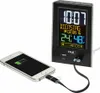 A digital alarm clock is shown charging a smartphone. Anteprima dell’immagine prodotto