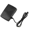 A black sewing machine foot pedal with a cord and plug, isolated on a white background. Produktbild-Vorschau