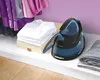 A steam iron station is placed on a shelf next to folded clothes. Náhľad obrázku produktu
