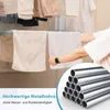 A person is using a drying rack with towels and clothes hanging on it. A close-up of metal tubes is shown in the lower right corner. Voir les images du produit