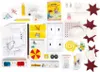 A collection of items for an advent calendar, including craft supplies, toys, and educational materials, laid out on a white background. Náhled obrázku produktu