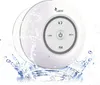 A white, round Bluetooth speaker is shown partially submerged in water, with water splashing around it. Voir les images du produit