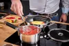 A person is cooking on a stovetop. Produktbild-Vorschau