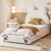 A child's bed with a bear-shaped headboard and paw-shaped footboard, decorated with bedding and a throw blanket. Produktbild-Vorschau