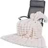 A cream-colored faux fur blanket draped over a dark gray office chair. Produktbild-Vorschau
