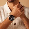 A close-up shot of a man's wrist wearing a black and silver Casio Edifice watch. Voir les images du produit