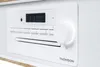 A close-up, angled view of the front panel of a white Thomson micro-stereo system. Voir les images du produit