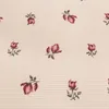 A repeating pattern of small floral designs on a textured background. Produktbild-Vorschau