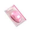 A pink paper punch in its original packaging, shown at an angle against a white background. Produktbild-Vorschau