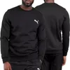 A man wearing a black Puma sweatshirt, shown from the front and back. Produktbild-Vorschau