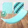 A turquoise balance board is shown on a wooden floor, with close-up insets highlighting its textured surface and grip. Podgląd zdjęcia produktu