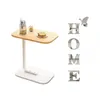 A small side table with a glass of water and toast, next to decorative letters spelling "HOME" and a butterfly. Anteprima dell’immagine prodotto