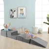 Two babies playing on a set of soft foam climbing blocks in a room with cartoon animal art on the wall. Anteprima dell’immagine prodotto