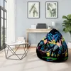A bean bag chair with an elephant and palm tree design is placed in a modern living room setting next to a coffee table and a desk. Voir les images du produit