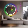 A modern bathroom with a round LED mirror, sink, and bathtub. Anteprima dell’immagine prodotto