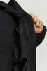 A person's hand is shown opening the inside pocket of a black jacket. Produktbild-Vorschau