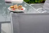 A close-up of a chair with a table and desserts in the background. Produktbild-Vorschau