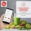 A hand holding a smartphone displaying a recipe app, with a blender and fresh ingredients in the background. Voir les images du produit