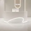 A modern, minimalist reception desk in a bright, clean space. Produktbild-Vorschau