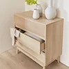 A wooden sideboard with one drawer open, displaying folded fabric. Decorative vases and a plant are on top. Produktbild-Vorschau