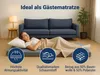A woman is sleeping on a folded mattress in front of a sofa, with marketing icons and text displayed. Produktbild-Vorschau