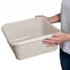 A person is holding a beige plastic basin. Anteprima dell’immagine prodotto